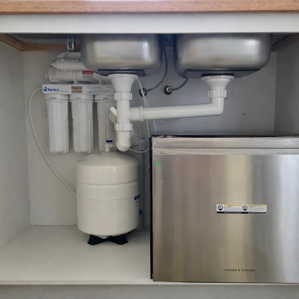 General home maintenance and repairs under kitchen sink plumbing and fittings