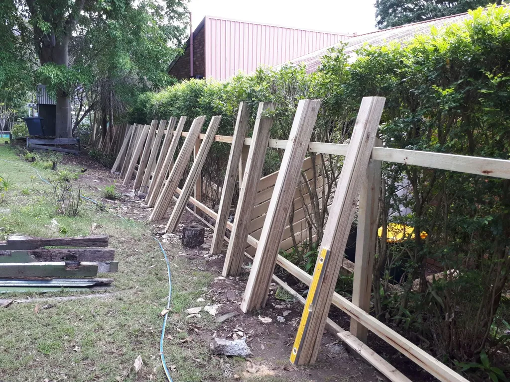 Standard two rail paling fence with palings spread out ready for installation.