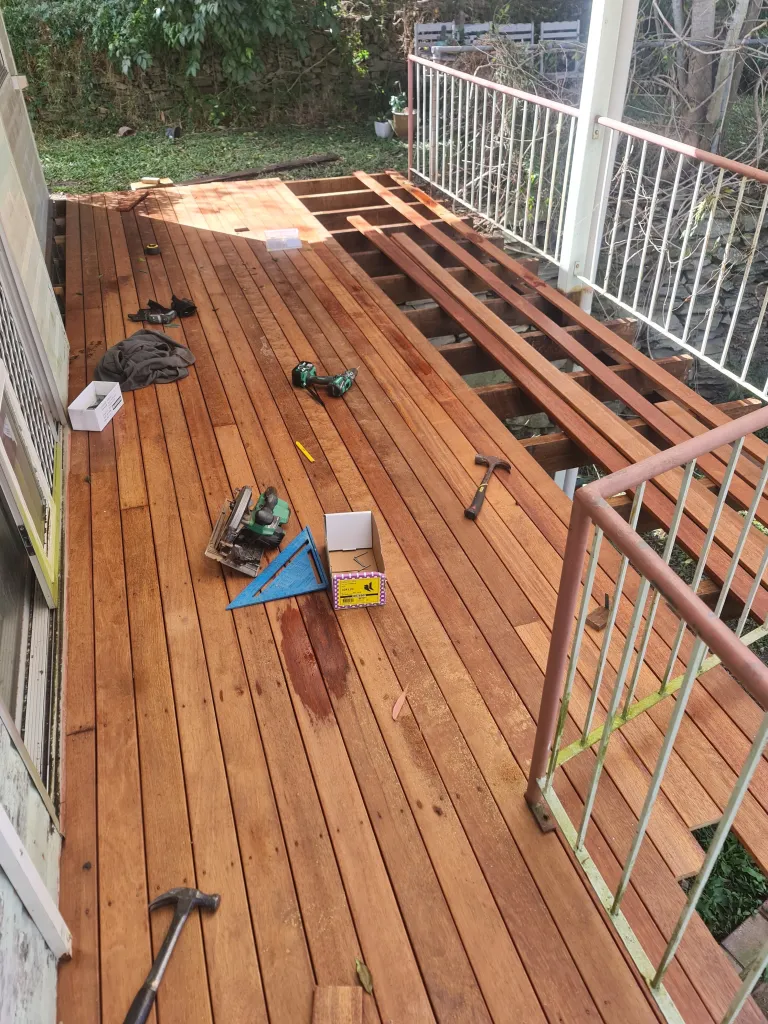 Deck rebuild showing partial completion of relaid decking boards.