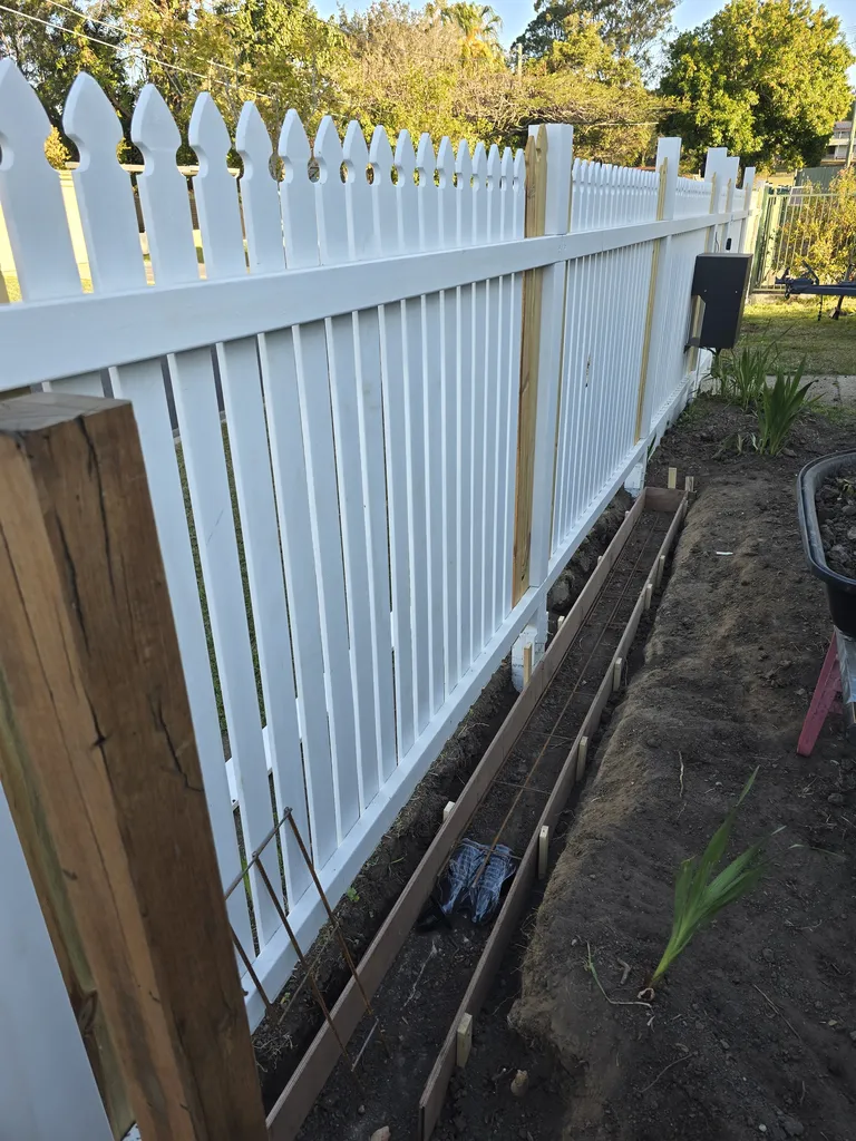 New colonial paling fence build with concrete footing for sliding gate install.